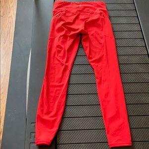Athleta red/orange contender tights in powerlift.